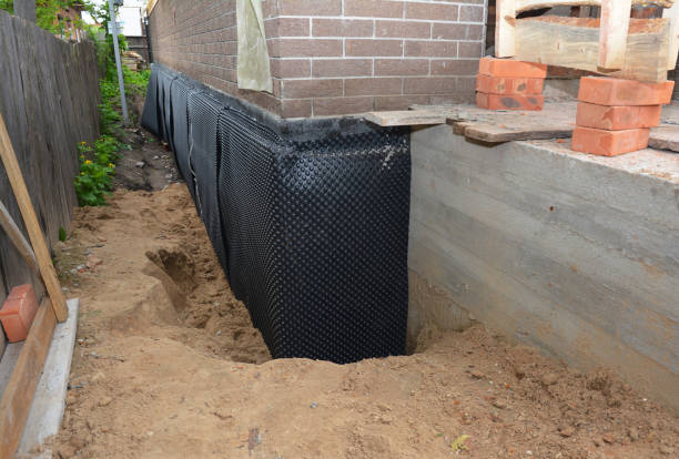 Happy homeowners after waterproofing job in Whiting